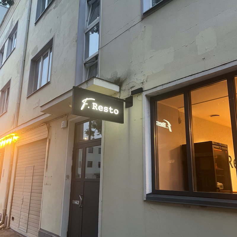Building exterior with a sign reading 'F. Resto' on a street corner.